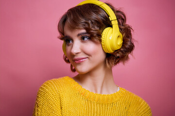 Close-up portrait of her she nice attractive lovely dreamy cheerful cheery wavy-haired girl music lover addict listening hit isolated over bright vivid shine vibrant yellow pink background