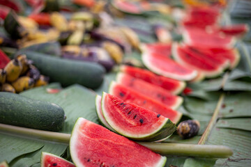 selective focus  Watermelon slices covered with banana leaves with various fruits. Elephant food at Thai Elephant Day, Elephant feeding fruit that it eats a lot of