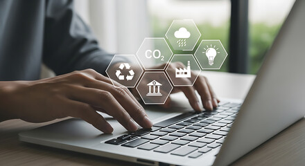 Person working on laptop with sustainability icons representing environmental concepts