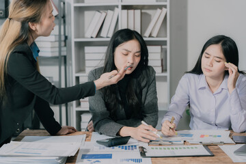Three Asian business women making money from document graphs, analyzing ideas, teamwork, collaboration and planning with documents or business strategies in the office. business starting concept