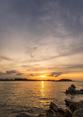 Sunset sea vertical background in the evening, Summer sky with orange, yellow, blue sunrise clouds sun dawn, Horizon beautiful tropical vecation sea, ocean sky landscape Dusk golden hour background