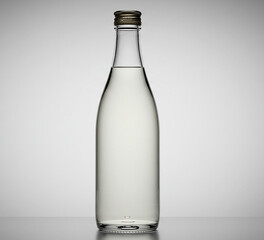 A clear bottle of water sits on a wooden table. ai generated