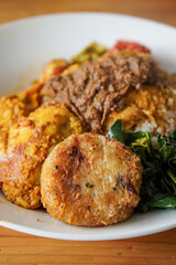 Grilled Chicken, Padang Style, Indonesia, captured on June 25, 2025. Traditional Minang-style grilled chicken marinated in rich spices and served with curry sauce, rice, and sambal.