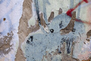 Abstract urban graffiti with distressed texture on concrete wall. Features muted colors, rough surface, street art vibe. Background, texture, grunge visuals, modern 90s, 2000s element.