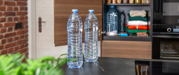 Banner of two water bottles placed on kitchen counter, in front of pantry with 72 hours survival...