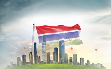 The Gambia national flag wavering with modern building skyline. Country showing stronger and prosperity. Flag key visual. The Gambia national flag for independence day.