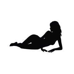 Silhouette of a seductive woman posing provocatively while reclining on her side