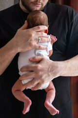 Man Holding Newborn Baby in Tender Moment