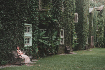 Teenage girl relaxing amid lush greenery serene garden setting photography outdoor perspective