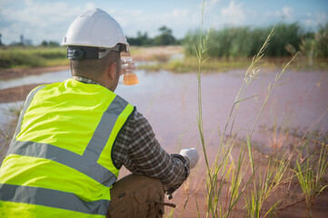 An environmental engineer examines water samples from a natural to identify organisms in ecosystem