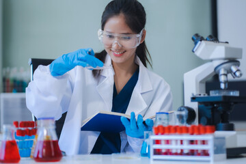 scientist researcher conducting an experiment working in the chemical laboratory.