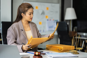 Business woman and lawyers discussing contract papers sitting in the table at office.
