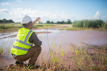 An environmental engineer examines water samples from a natural to identify organisms in ecosystem