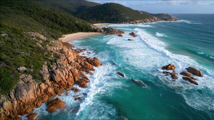 Aerial scene of waves sweeping onto a wide rocky coast during high tide