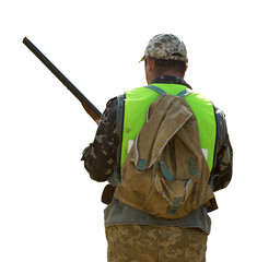 Hunter man in camouflage with a gun during the hunt in search of wild birds or game.
