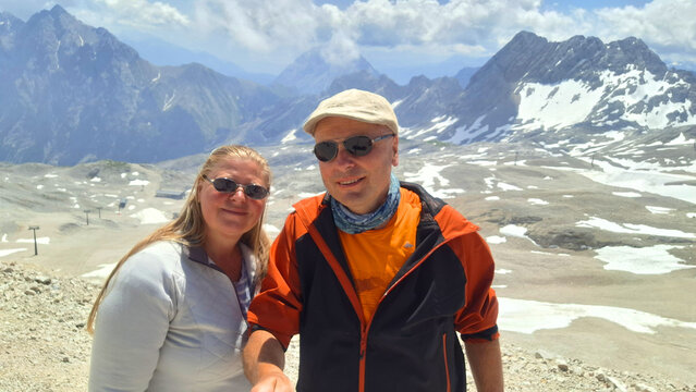 Happy couple of hikers on The Zugspitze mountain. Bavaria, Germany.