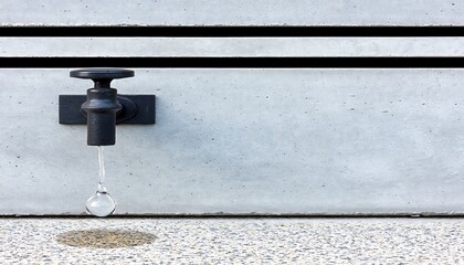 Modern water tap on a concrete wall