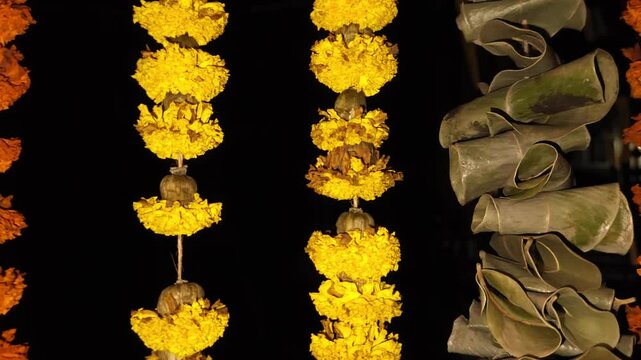 Beautiful marigold flower garland with green mango leaves hangs as a traditional decorative border in the background, symbolizing Indian culture, religion, and festive celebrations like Diwali, Pongal