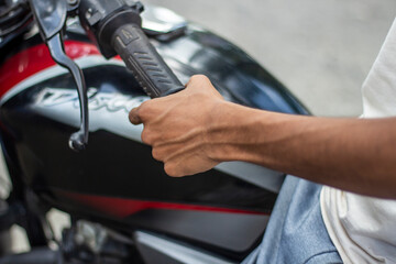 A young boy holding a motorcycle handle
