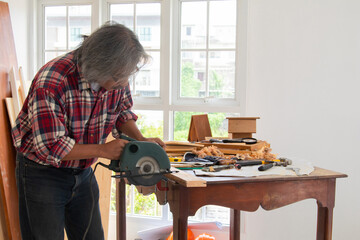 Elderly lifestyle working after retirement concept, healthy senior carpenter happy working in...