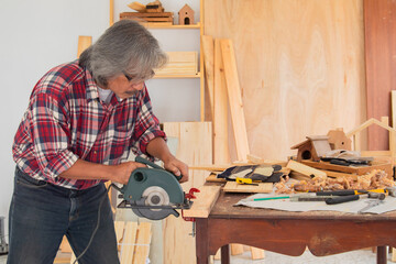 Elderly lifestyle working after retirement concept, healthy senior carpenter happy working in...