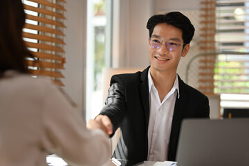 Business Agreement and Partnership Concept, Confident businessman wearing a suit smiling during a...