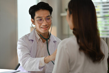 A Professional physician conducting a heart and lung examination, showing care and attention during a medical consultation
