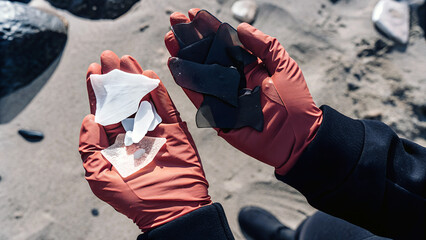 Person holding beach debris collected showing the importance of environmental clean up