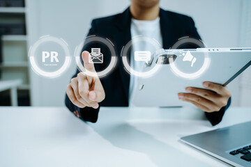 PR, Public relations concept. hands using laptop and tablet with public relations icon