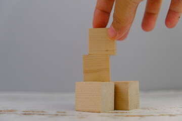 wooden blocks scattered on the wooden table with wooden figures as a people concept. 