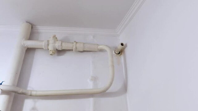Clear close-up of residential plumbing lines showing a neat layout of pipes, connectors, and valves. Ideal for installation guides, tutorials, or maintenance references