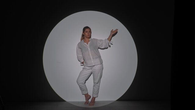 Fototapeta Person Posing Artfully Inside a Circle of Light