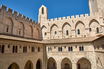 Fototapeta premium The inner courtyard of the Popes' Palace in Avignon, Provence, under a resplendent blue sky