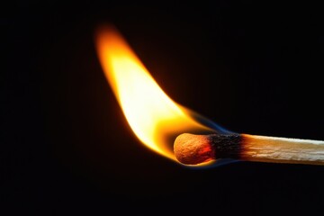 Close-Up of a Fiery Match Igniting Against a Dark Backdrop