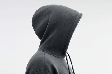Minimalist image showcasing a gray hooded sweatshirt, focusing on its texture, form, and simplicity against a stark white background.