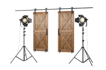 Two barn doors hanging with lights on stands creating a studio setup for photography or videography