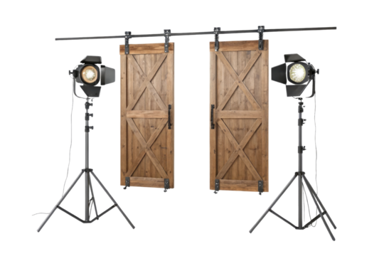 Two barn doors hanging with lights on stands creating a studio setup for photography or videography
