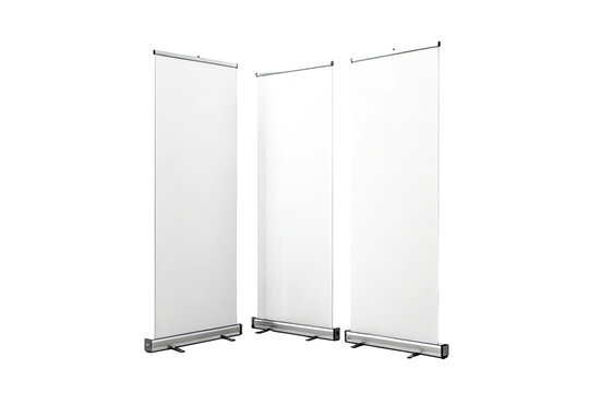 Three white blank roll up banners standing side by side against a black background in a studio setting