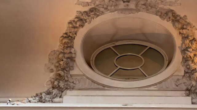 Close-up of an ornate English ceiling with plaster moulding and a circular vent detail framed in classic symmetry, softly lit in heritage tones, slow motion
