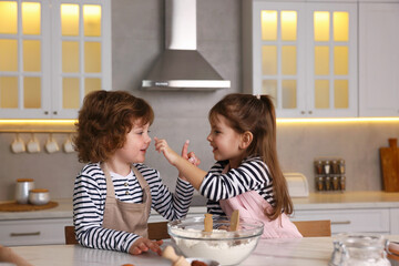 Cooking recipe. Little children making dough for cookies at table in kitchen