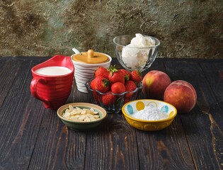 Ingredients for making Dessert peach melba, vanilla ice cream with strawberry sauce, peach in syrup...