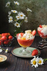 Dessert peach melba, vanilla ice cream with strawberry sauce, peach in syrup and whipped cream in a...