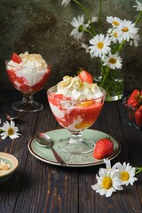 Dessert peach melba, vanilla ice cream with strawberry sauce, peach in syrup and whipped cream in a...
