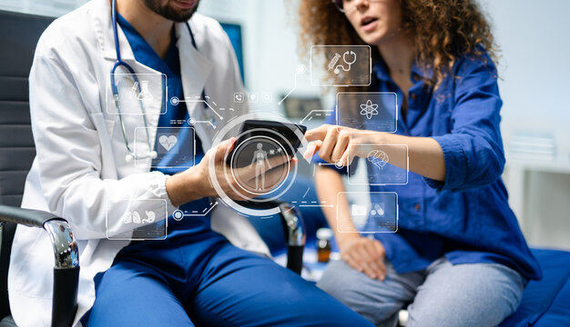 Doctor consults patient using digital tablet with holographic medical interface. Concept of telehealth, smart healthcare, AI