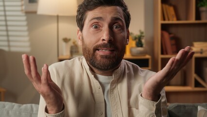 Caucasian man homeowner guy at home shrug shoulders unsure confused male stress uncertain homeowner...