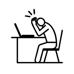 A stressed man sitting at a desk with a laptop, isolated on white background