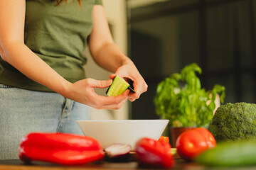 Woman cutting fresh vegetables in the kitchen. Healthy cooking, food preparation and lifestyle...