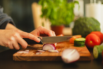 Woman cutting fresh vegetables in the kitchen. Healthy cooking, food preparation and lifestyle...
