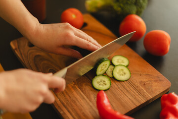 Woman cutting fresh vegetables in the kitchen. Healthy cooking, food preparation and lifestyle...