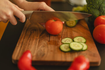 Woman cutting fresh vegetables in the kitchen. Healthy cooking, food preparation and lifestyle...